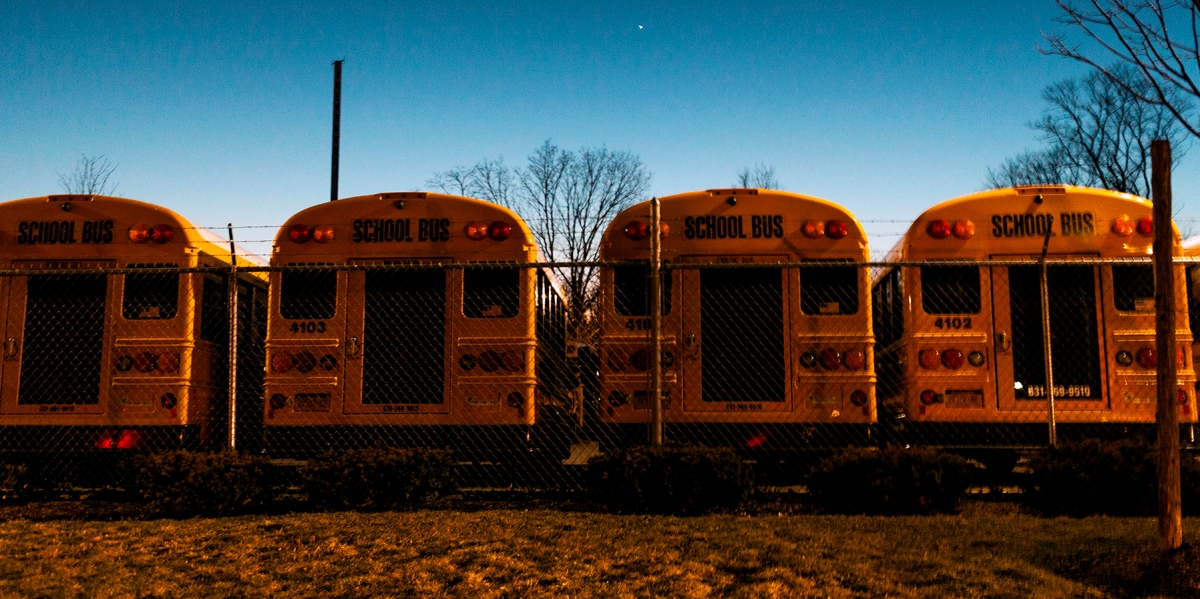 A fleet is buses is parked at the back of Brentwood High School after a hectic day. The demand of buses increased considerably after the murders of Nisa Mickens and Kayla Cuevas, with parents who wouldn't let their kids walk to school. "Since then, I always have to take the bus. I miss walking home," said Madeline Diaz, a friend of Nisa. Even after the indictments against 13 people on charges of gang affiliation, and over 140 people detained on suspicions of MS-13 affiliation, her family still worries constantly.***Brentwood, New York, was shocked after two teenage girls, 15-year-old Nisa Mickens and 16-year-old Kayla Cuevas, were found dead in the backyard of a nearby home. In the last semester of 2016, a total of six bodies were found in Brentwood. The SCPD has repeatedly said to believe that all of the murders were product of gang violence, and thirteen people have been federally charged with the murders.Brentwood has had gang activity for over 12 years, with the presence of Bloods, Crips, MS-13 and MS-18 but the gruesome murders have led to panic in the community.Brentwood, New York, 2017.