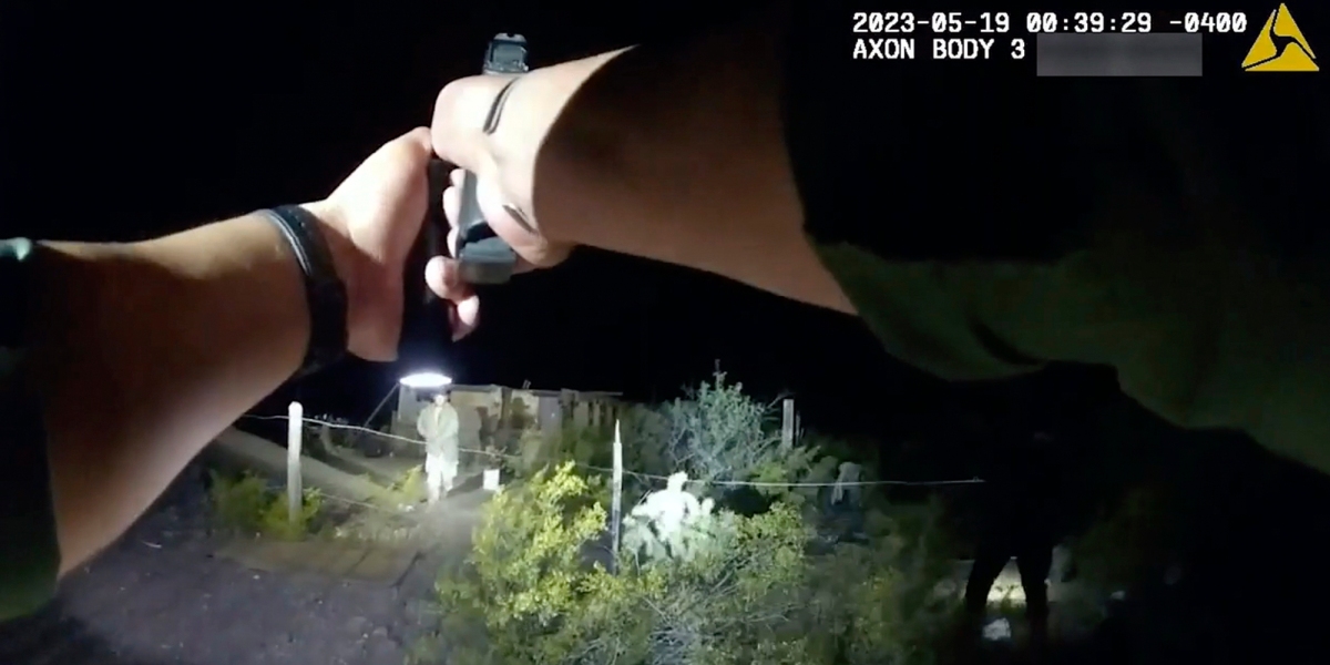 In this image taken from body camera video released Thursday, June 22, 2023, by U.S. Customs and Border Protection, an agent points a gun at tribal member Raymond Mattia, early Friday, May 19, in Tohono O'odham Nation, in southern Arizona.