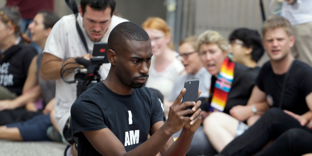 FILE - In an Aug. 10, 2015 file photo, protester and social media activist DeRay McKesson records outside the Thomas F. Eagleton Federal Courthouse Monday, in St. Louis. Mckesson has joined the crowded 2016 Baltimore mayoral race. Maryland's State Board of Elections shows that he filed Wednesday, Jan. 3, 2016, to run in the Democratic primary along with 12 other candidates. Photo: Jeff Roberson/AP