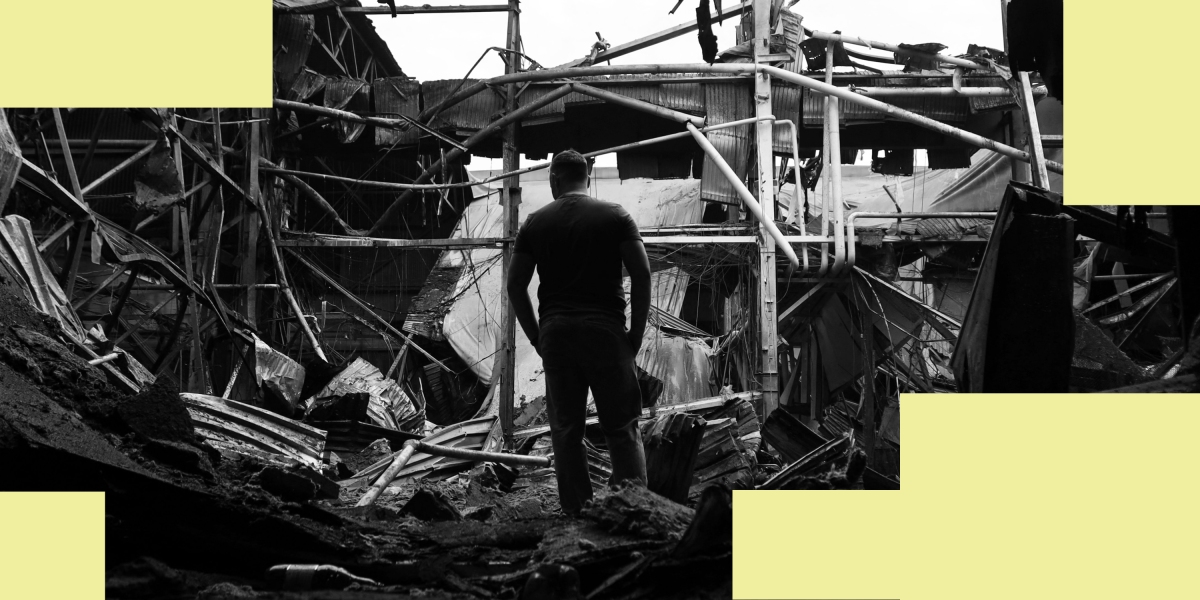A man walks among debris in a damaged warehouse after a strike in Odesa, on June 14, 2023.
