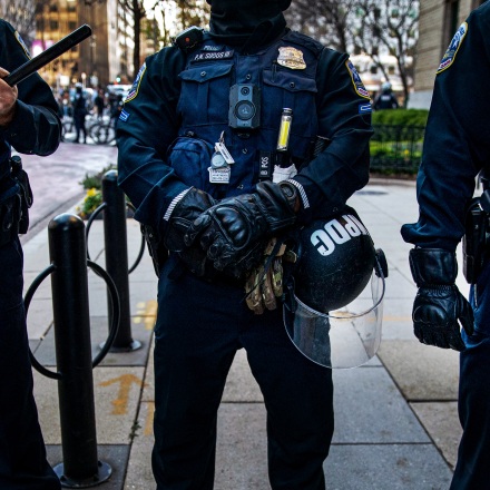 WASHINGTON, DC - DECEMBER 12: Members of the Metropolitan Police Department stand guard as they separate counter-protesters from supporters of President Trump near Black Lives Matter Plaza, on December 12, 2020 in Washington, DC. Thousands of protesters who refuse to accept that President-elect Joe Biden won the election are rallying ahead of the electoral college vote to make Trump's 306-to-232 loss official. (Photo by Al Drago/Getty Images)