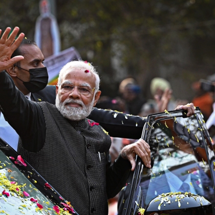 India's Prime Minister Narendra Modi (C) waves to his supporters during a roadshow ahead of the BJP national executive meet in New Delhi on January 16, 2023. (Photo by Sajjad HUSSAIN / AFP) (Photo by SAJJAD HUSSAIN/AFP via Getty Images)