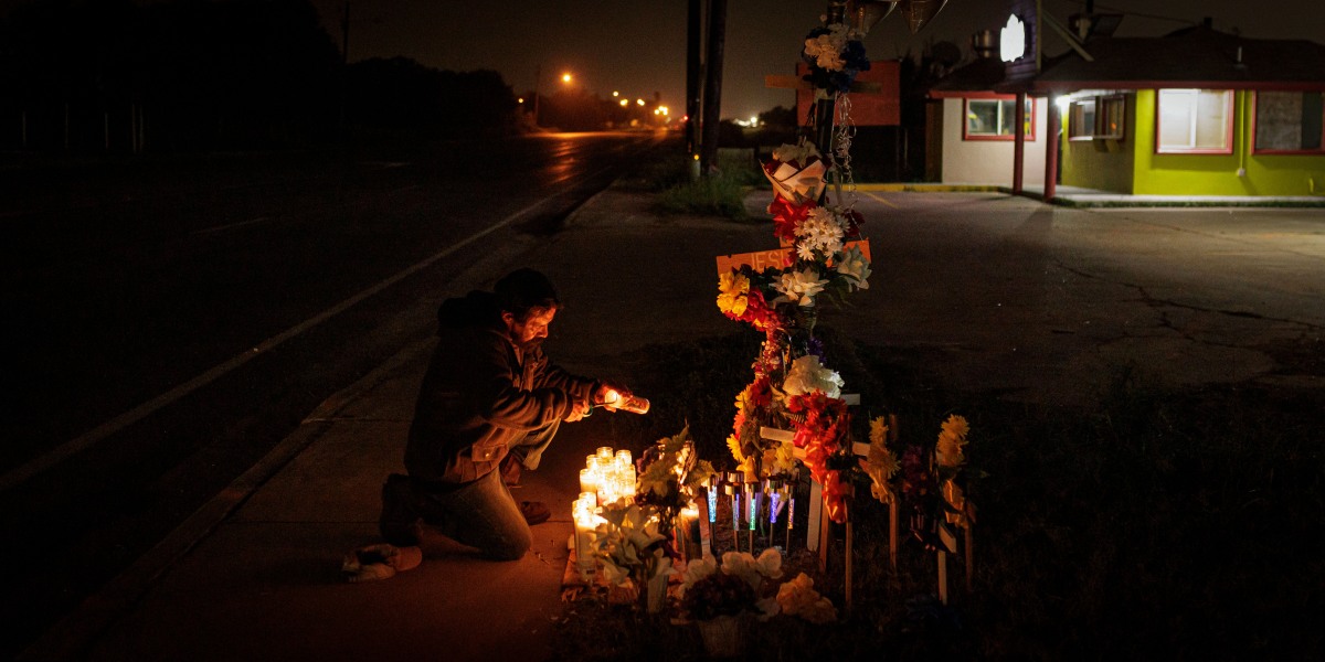 BROWNSVILLE, TEXAS - MAY 7: A man lights a candle at a memorial for eight migrants that were run over and killed today waiting at a bus stop on May 7, 2023 in Brownsville, Texas. George Alvarez was arraigned on eight counts of manslaughter and 10 counts of aggravated assault with a deadly weapon after the SUV he was driving ran a red light,  lost control and flipped on its side, striking 18 people, according to published reports.  (Photo by Michael Gonzalez/Getty Images)