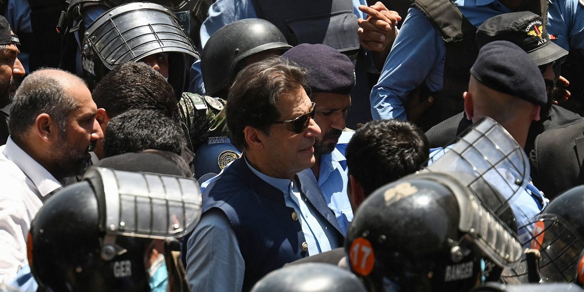 Police cammandos escort former Pakistan's Prime Minister Imran Khan (C) as he arrives at the high court in Islamabad on May 12, 2023. Former Pakistan prime minister Imran Khan was granted bail by the Islamabad High Court on May 12, after his arrest on corruption charges this week sparked deadly clashes before being declared illegal. (Photo by Aamir QURESHI / AFP) ( QURESHI/AFP via Getty Images)