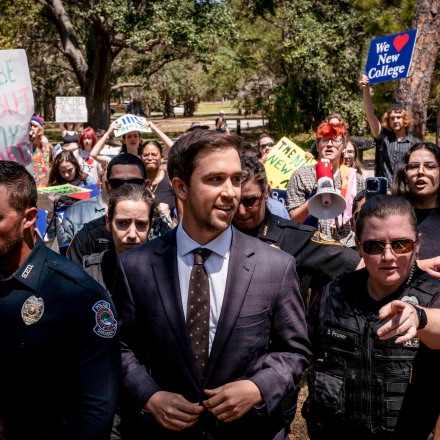 SARASOTA, FL - MAY 15: Christopher Rufo, a conservative activist and New College of Florida trustee, walks through protestors on his way out of a bill signing event featuring Florida Governor Ron DeSantis, who signed three education bills on the campus of New College of Florida in Sarasota, Fla. on Monday, May 15, 2023. (Photo by Thomas Simonetti for The Washington Post via Getty Images)
