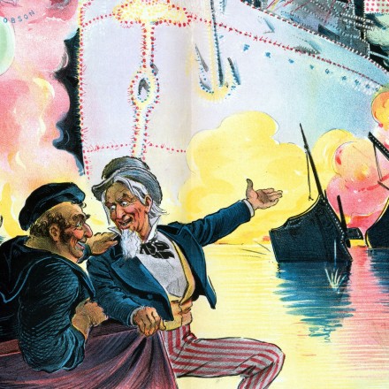 Celebrating July 4th, 1898, "the triumph of the American battle-ship" by Udo Keppler, 1872-1956, artist, 1898. Uncle Sam sitting with John Bull, who is a sailor representing England, and six figures representing "Spain", "Italy" (Umberto I), "Austria" (Franz Joseph I), "France", Germany (William II), and "Russia" (Nicholas II), watching a fireworks display that shows the outline of a huge American battleship that illuminates the ruins of the "Spanish Fleet", and in the clouds of smoke shows portraits of "Schley, Sampson, Hobson and Dewey". (Photo by: Universal History Archive/Universal Images Group via Getty Images)