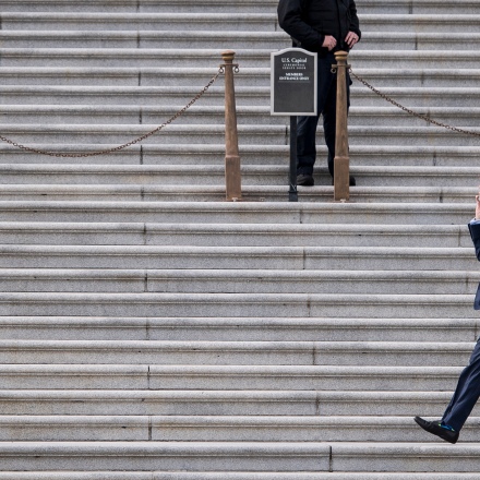 UNITED STATES - DECEMBER 6: Former Sen. Norm Coleman, R-Minn., walks along the Senate steps as Capitol Police officers stage for an expected dreamers protest on the steps on Wednesday, Dec. 6, 2017. The protest was held to call on Congress to find a legislative fix for the legal status of people brought into the country illegally as children. (Photo By Bill Clark/CQ Roll Call)