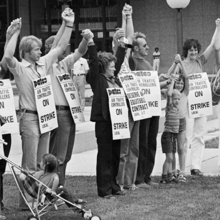 Members of PATCO, the air traffic controllers union, hold hands and raise their arms as their deadline to return to work passes. All strikers were fired on the order of President Reagan on August 5, 1981.